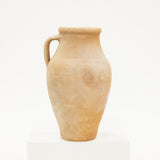 Beige ceramic pitcher on a white background