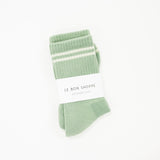 light green boyfriend style crew sock with white stripes and the white label saying the brand name le bon shoppe