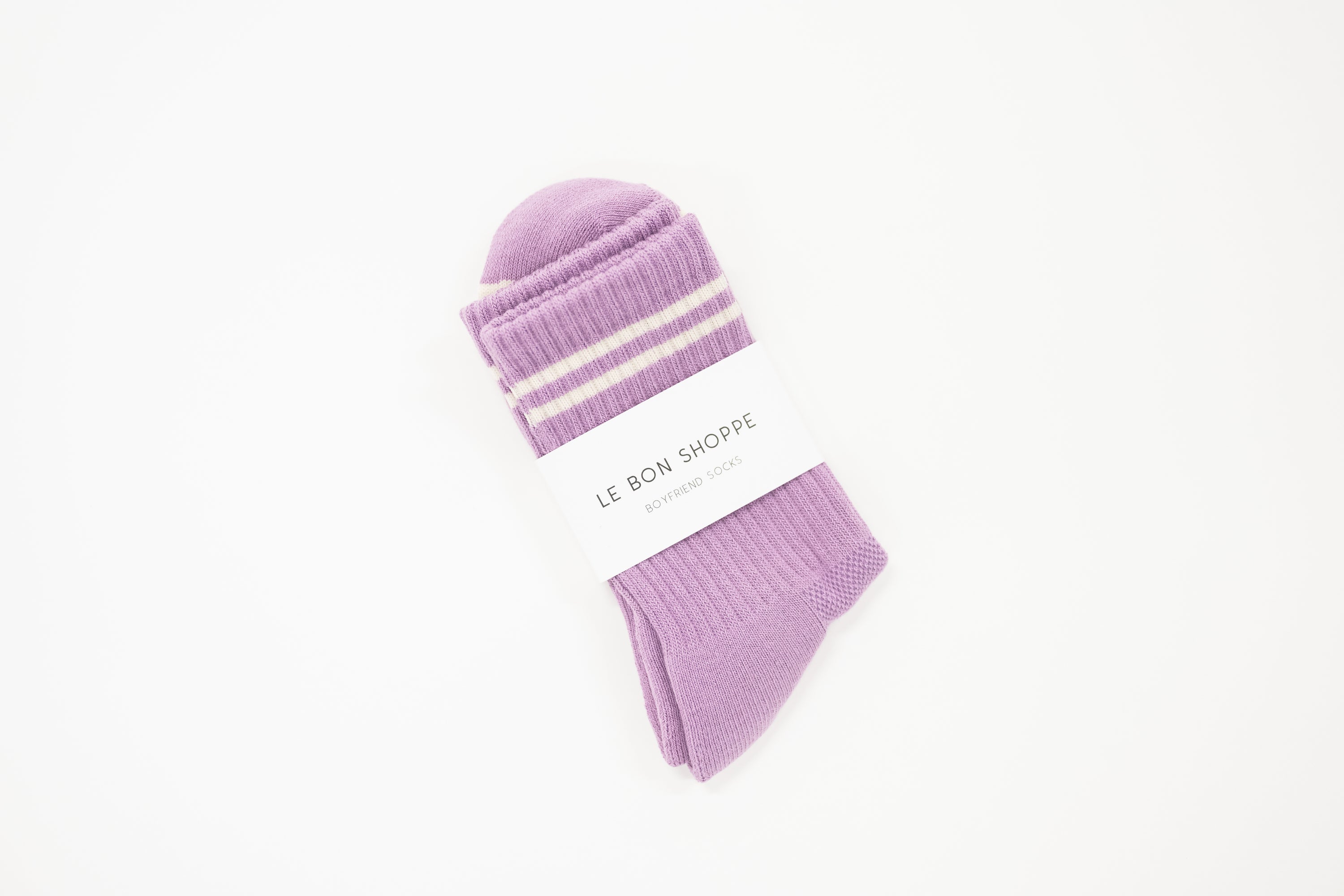 light purple crew boyfriend style sock with white stripes and a white label saying le bon shoppe.