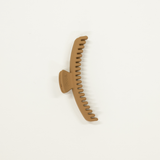 light brown matte colored midi sized kaxi hold everything hair claw