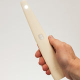 Hand holding a white usb lighter with a light on a plain background
