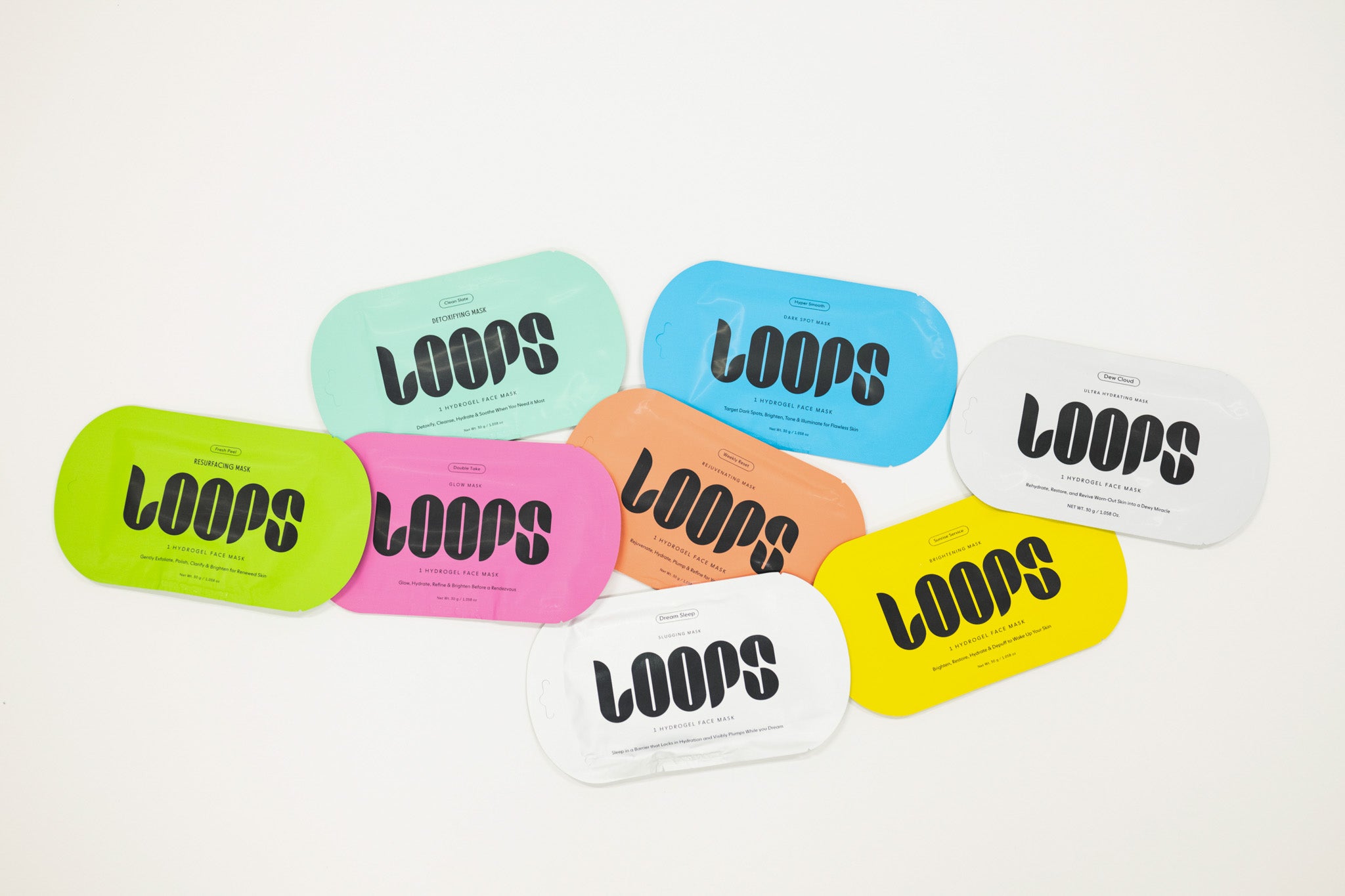 Colorful 'LOOPS' face masks on a light gray background