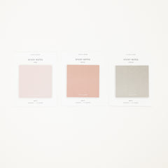 Three sticky notes in different colors on a white background