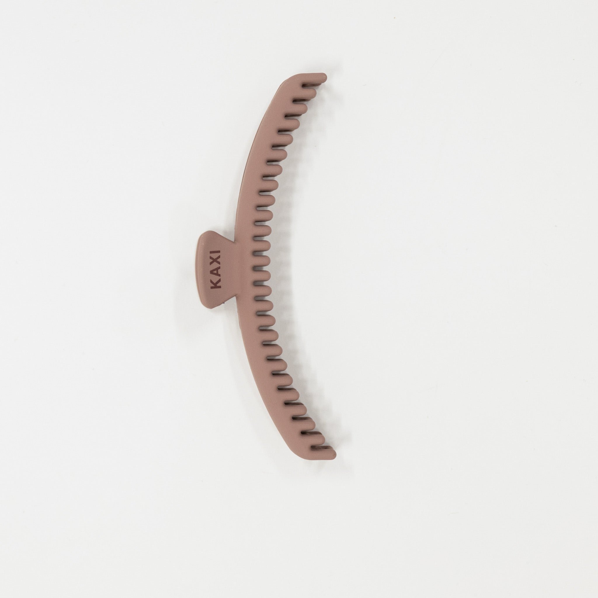 Pink hair comb with 'KAXI' branding on a white background
