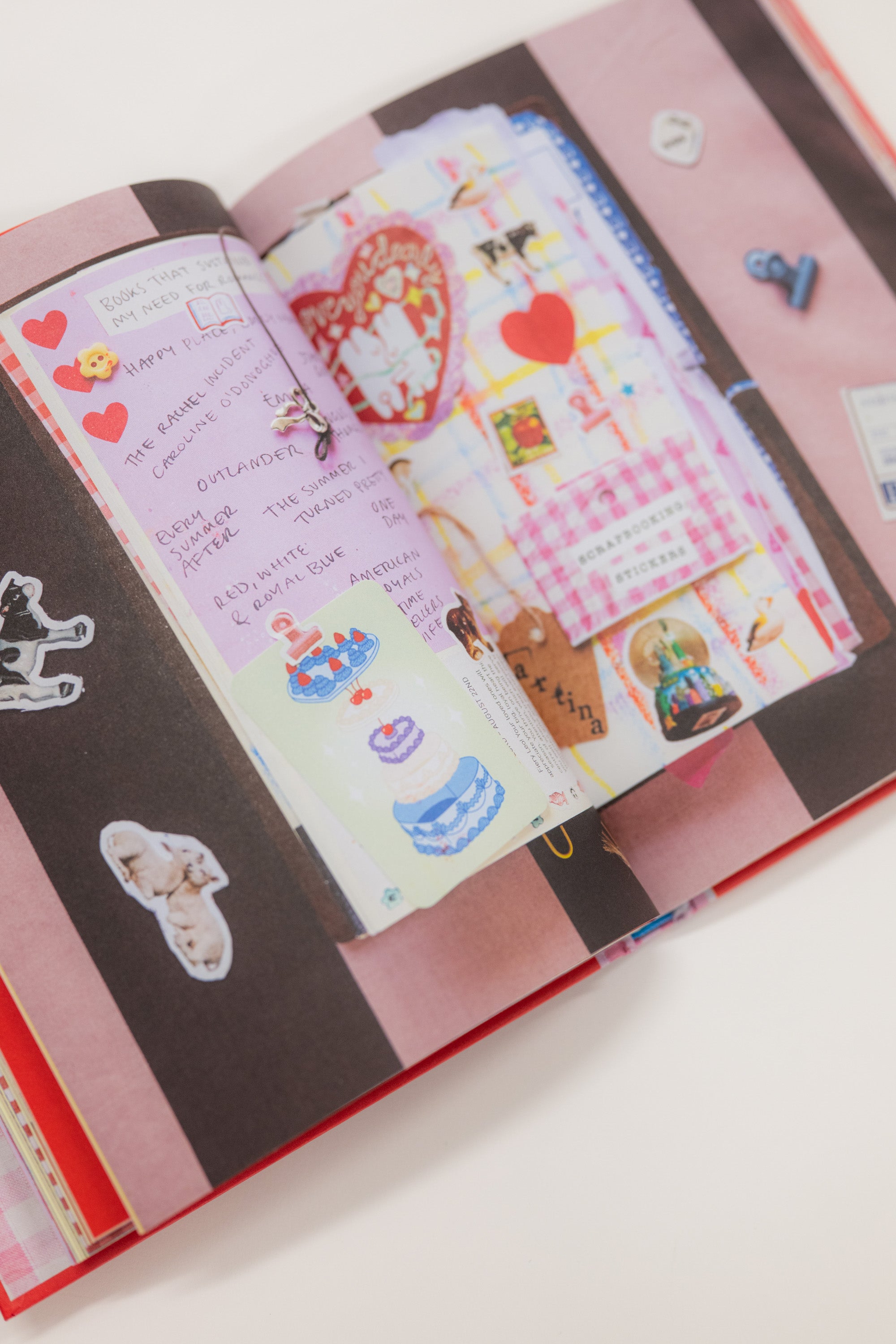 Open notebook with decorative stickers and drawings on a white background