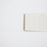 Spiral-bound planner on a white background