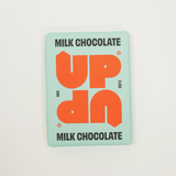 Milk chocolate bar packaging with 'UP' branding on a light gray background