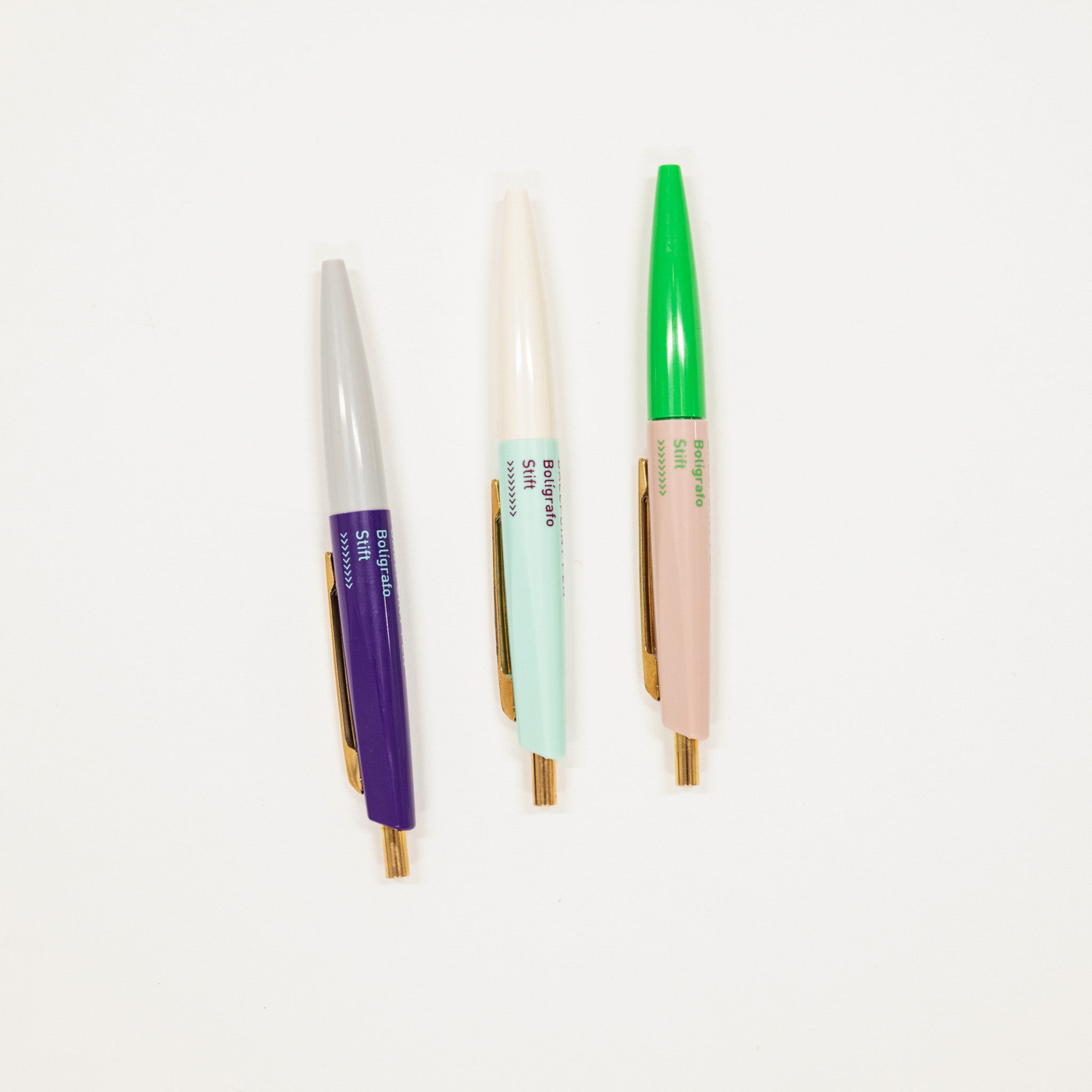 Three colorful mini pens on a white background