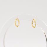 Gold hoop earrings on a white background