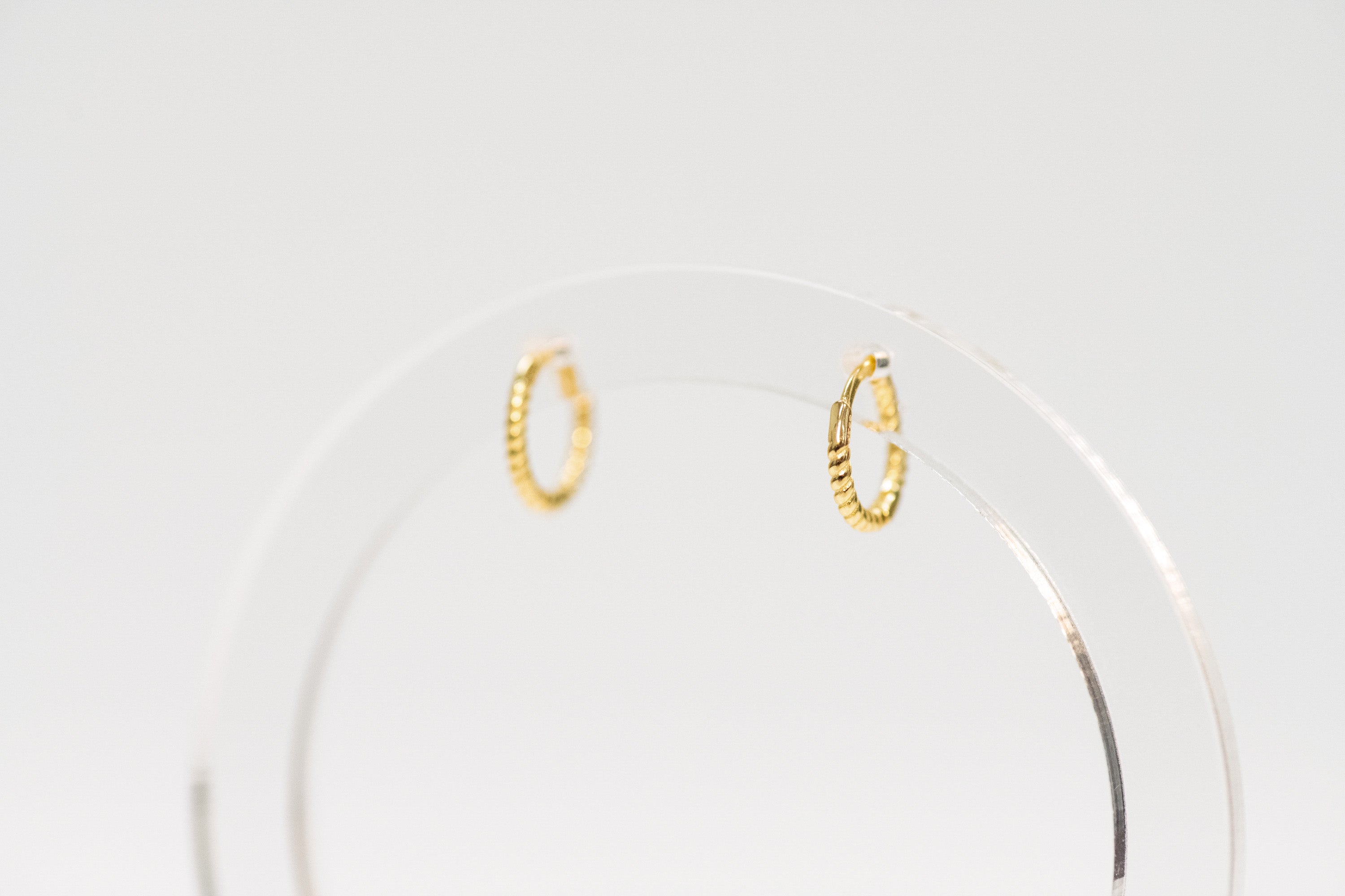 Gold hoop earrings on a white background