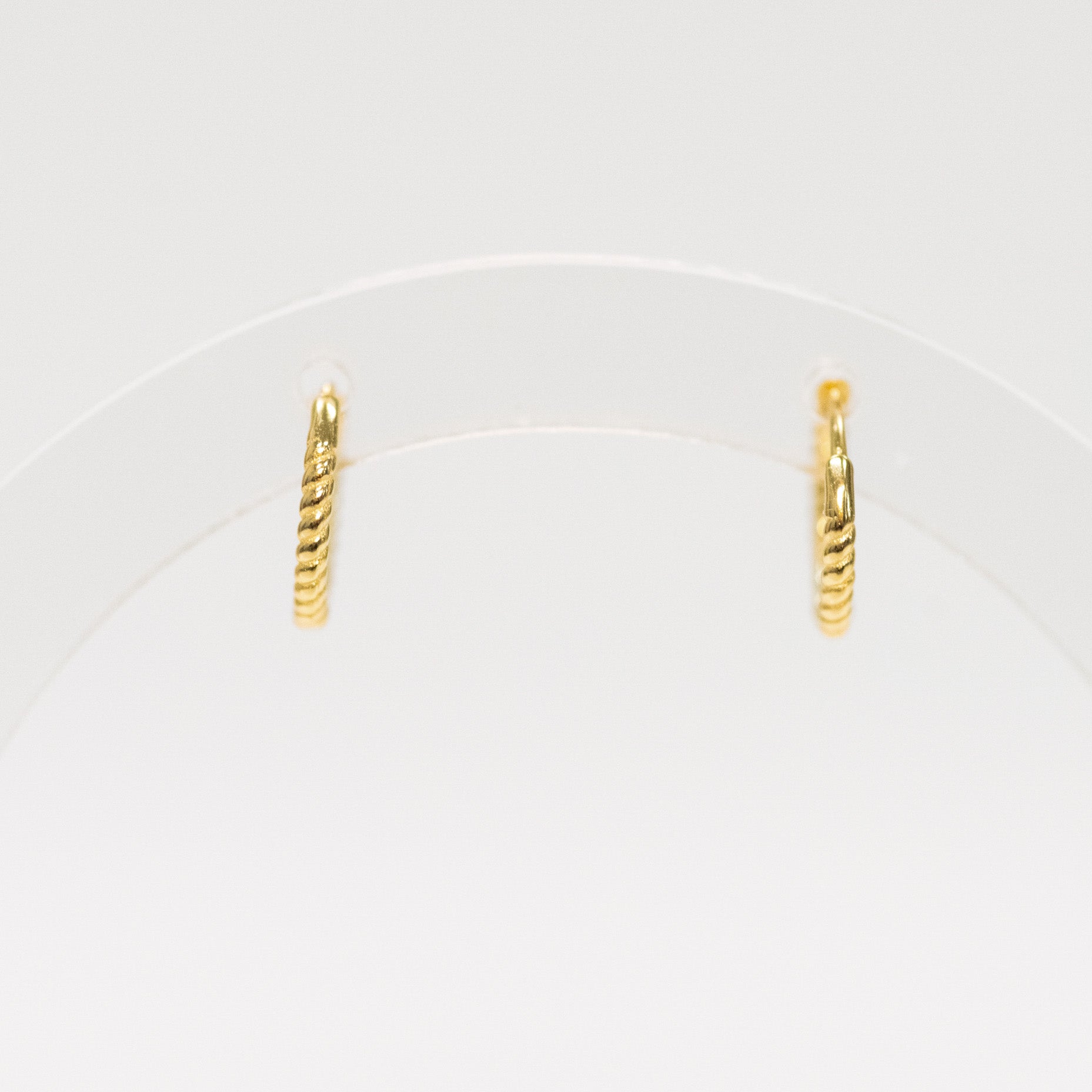 Pair of gold hoop earrings on a white background