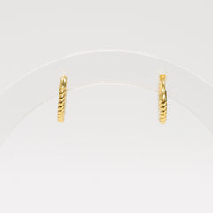 Pair of gold hoop earrings on a white background