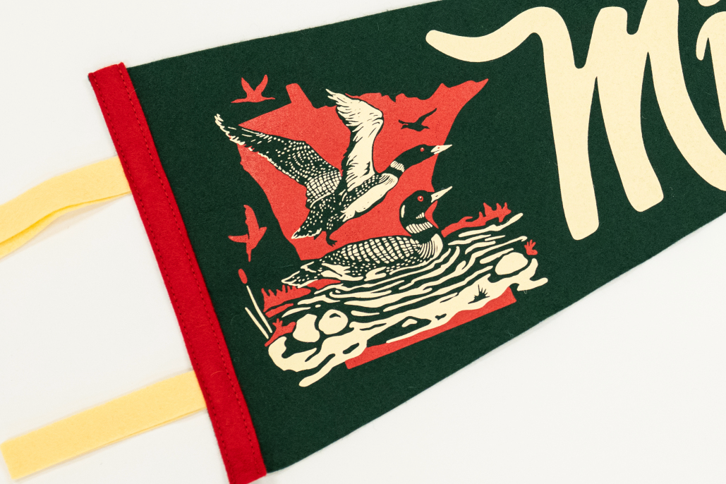 Fabric banner with duck design and text on a white background