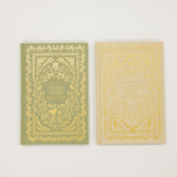 Two books with ornate covers on a white background