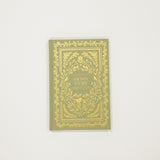 Green book with gold decorative cover on a white background