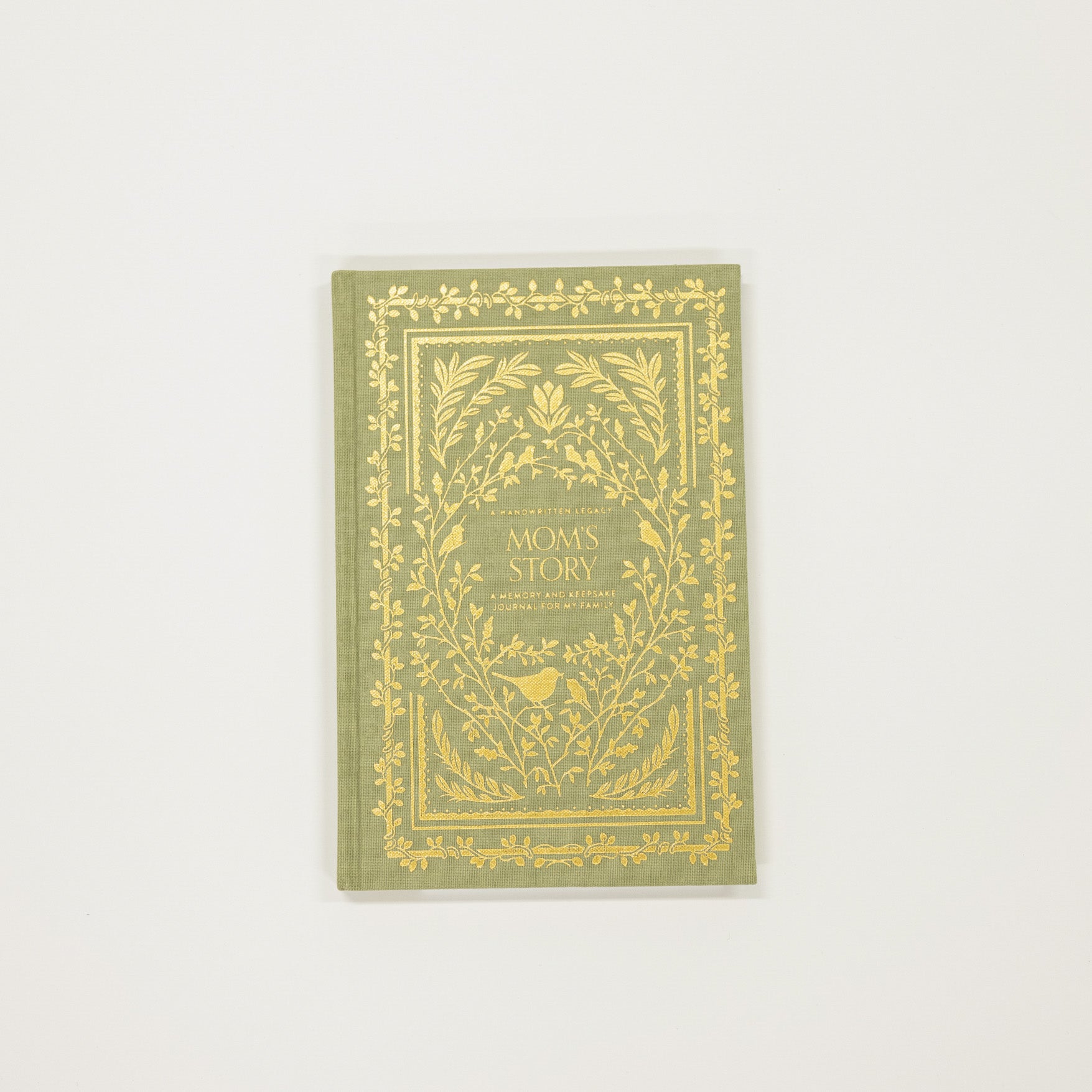 Green book with gold decorative cover on a white background