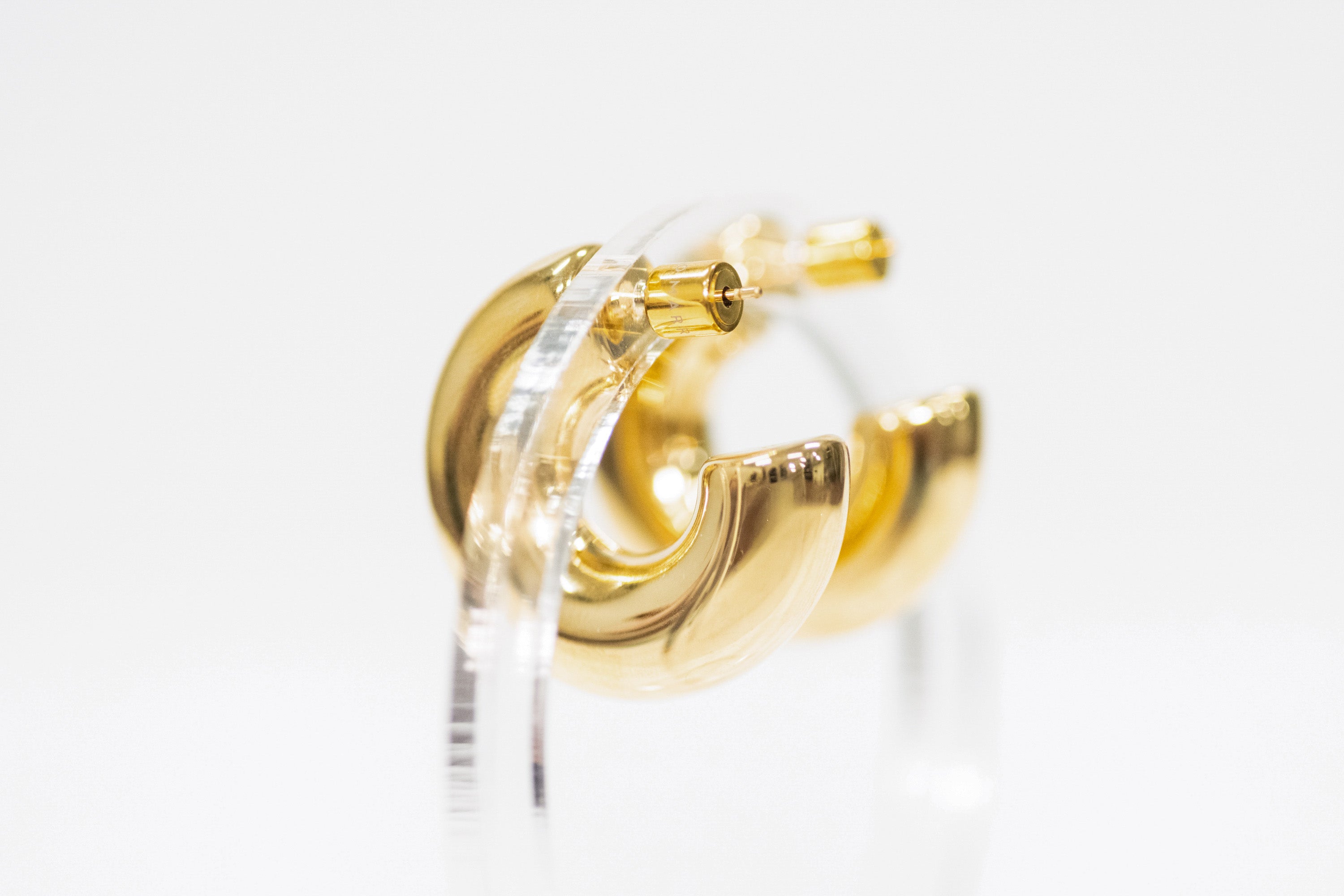 Gold hoop earrings on a white background