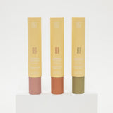 Three tubes of mosquito repellent incense with different colored caps on a white background