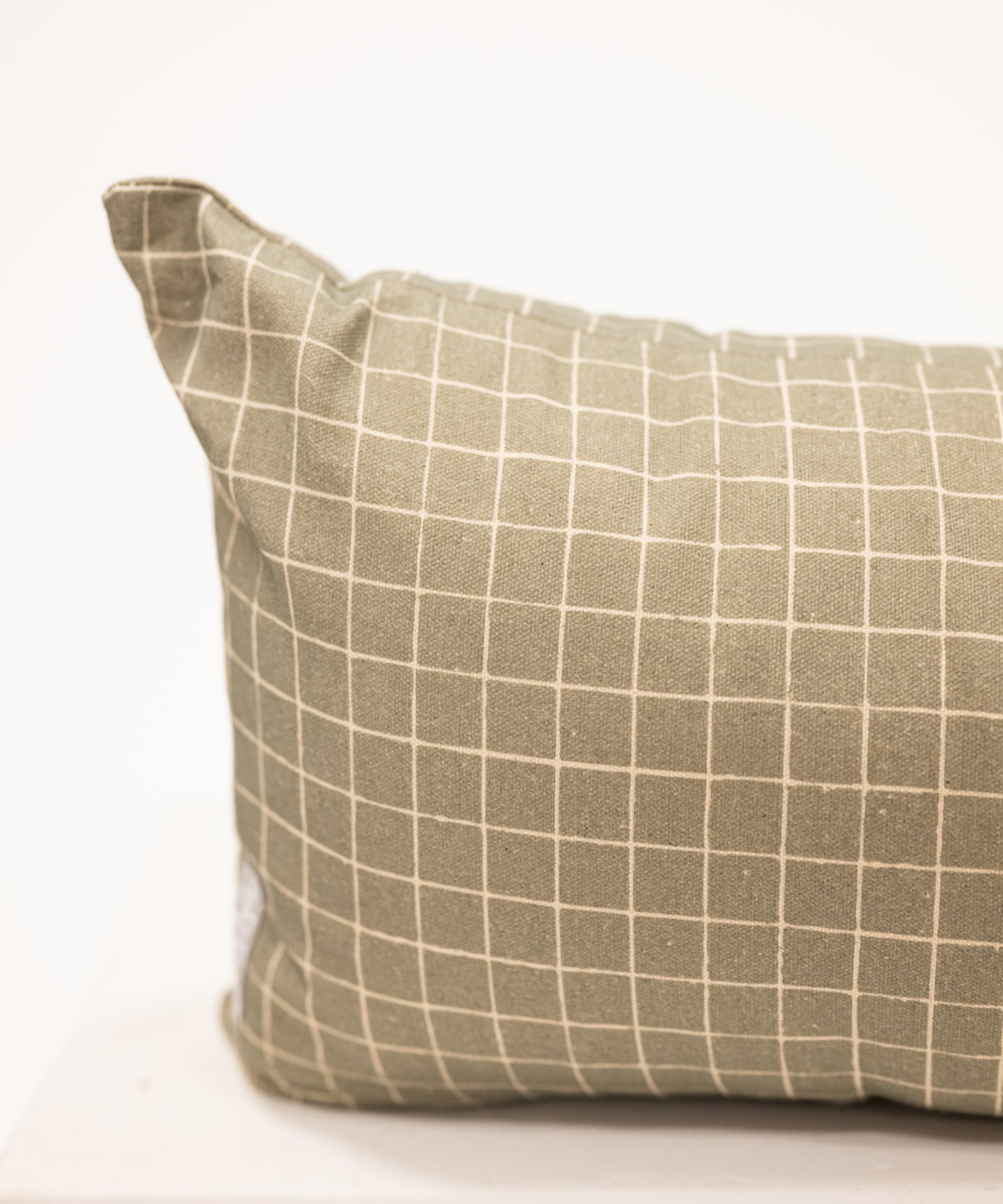 moss green with grid pattern on a long lumbar pillow