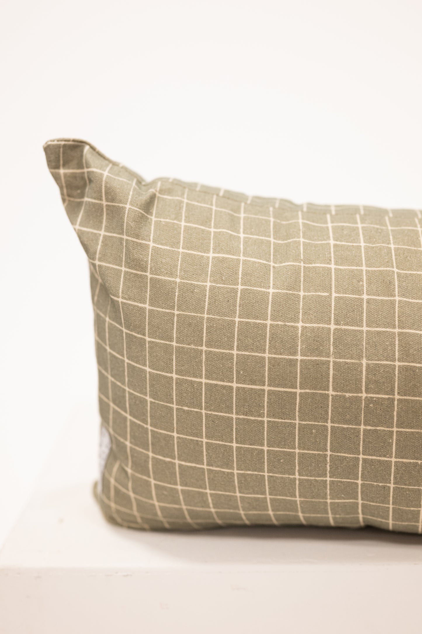moss green with grid pattern on a long lumbar pillow