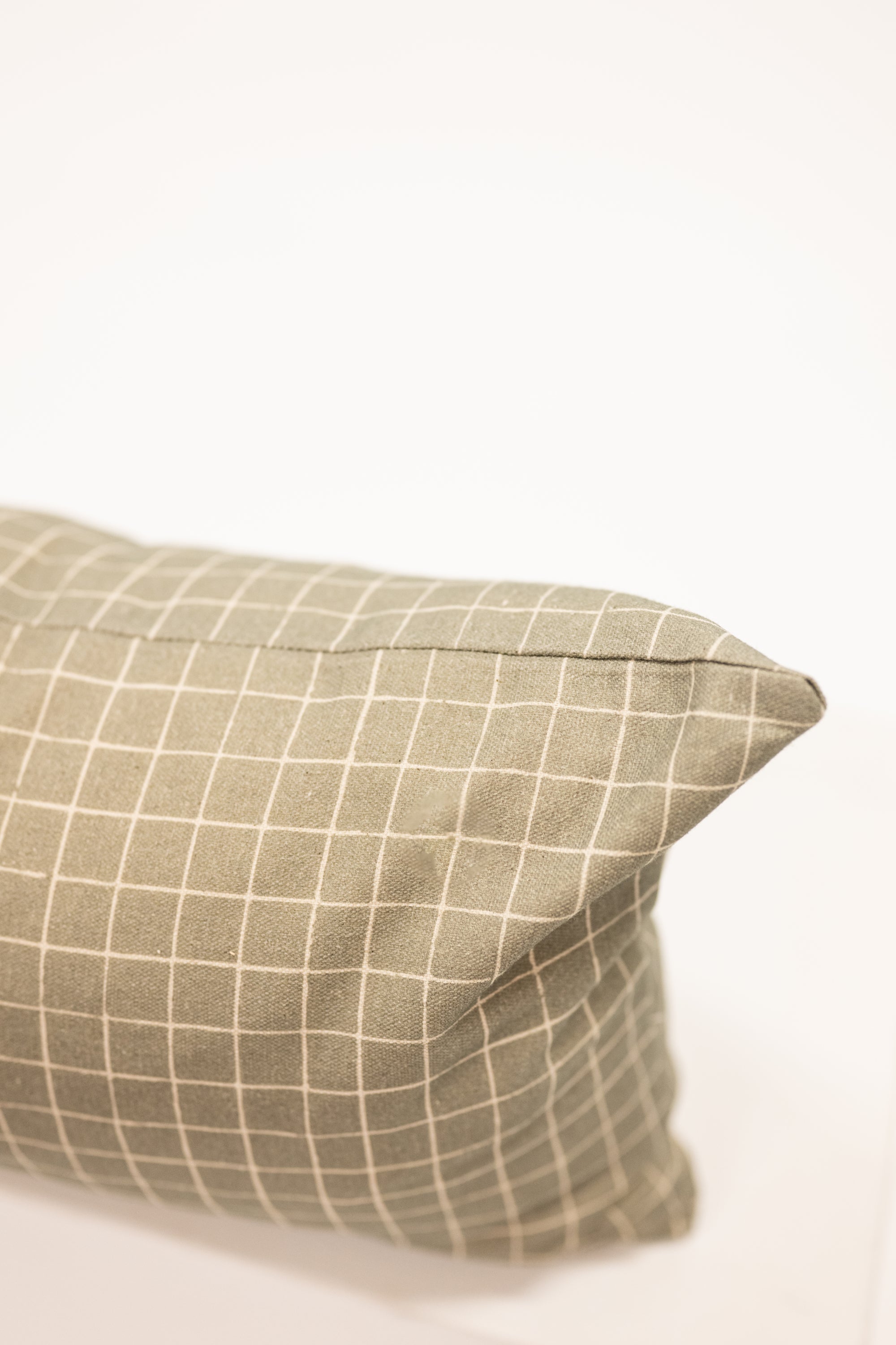 moss green with grid pattern on a long lumbar pillow