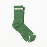 A pair of green ribbed crew socks with white stripes near the cuff and a white stripe detail on the toe, displayed on a clean white background.