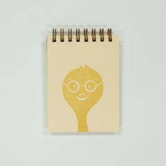 Notebook with a yellow chick wearing glasses design on a light gray background