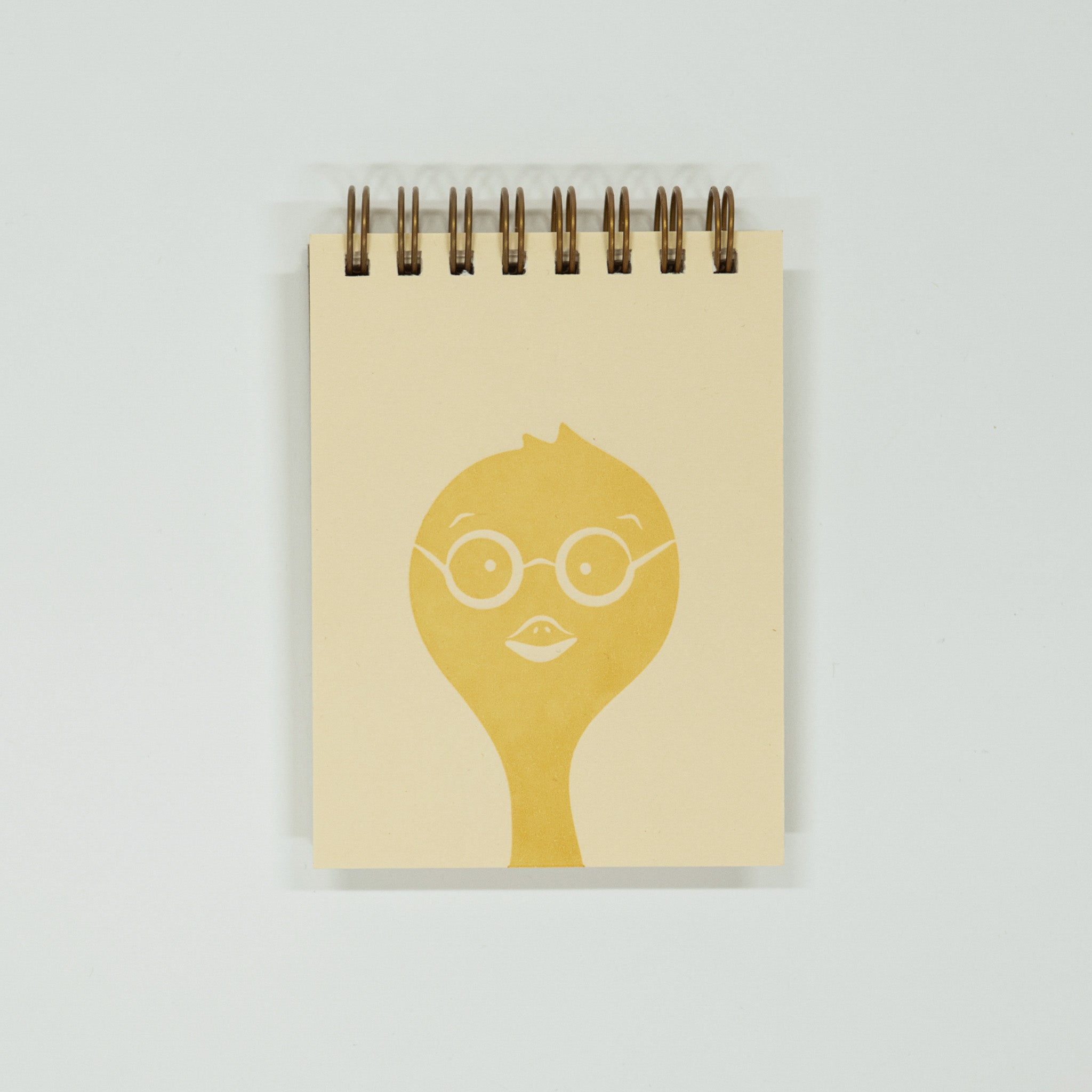 Notebook with a yellow chick wearing glasses design on a light gray background