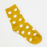 mustard colored socks with puff raised white dots