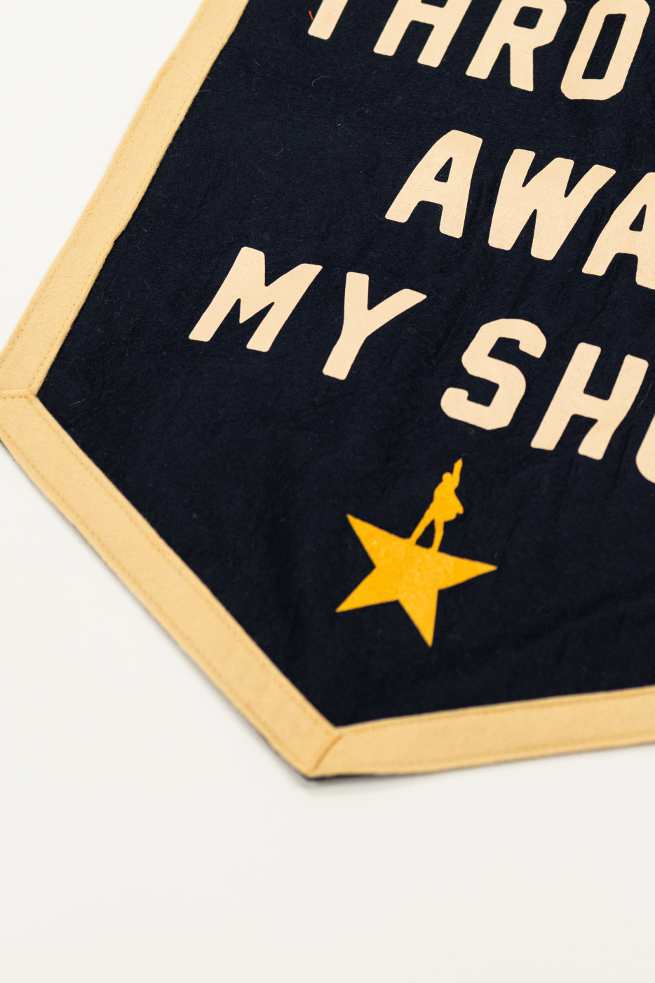 detail shot of felt banner with "i'm not throwing away my shot" quote from hamilton