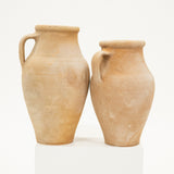 Two terracotta pots on a white background