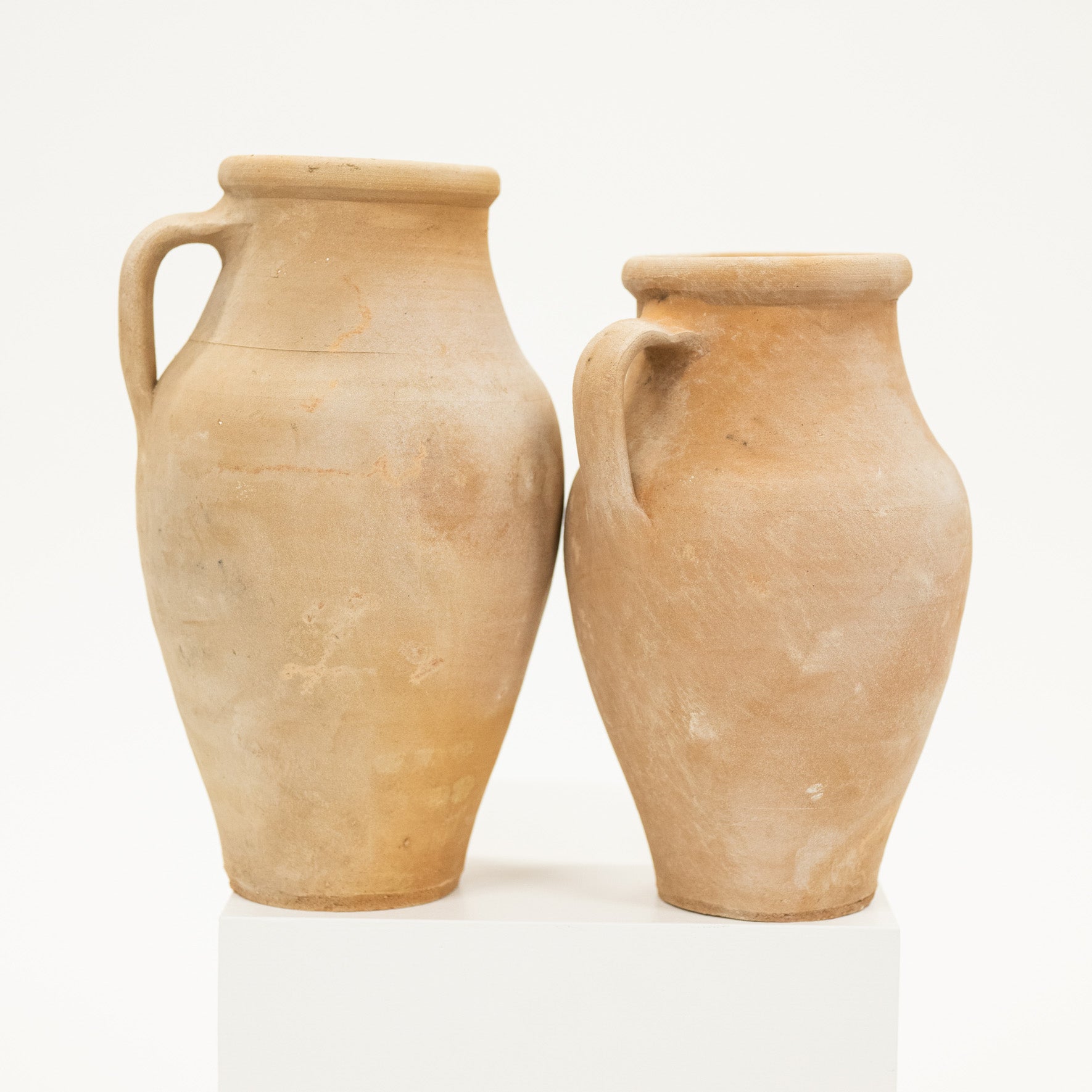 Two terracotta pots on a white background