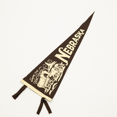 Nebraska-themed pennant with logo and text on a white background