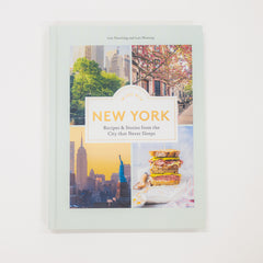 Book titled 'New York: Recipes & Stories from the City that Never Sleeps' with cityscape images on the cover.