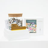 Glass jar of puzzle pieces, with glue and applicator, and a box on a white background