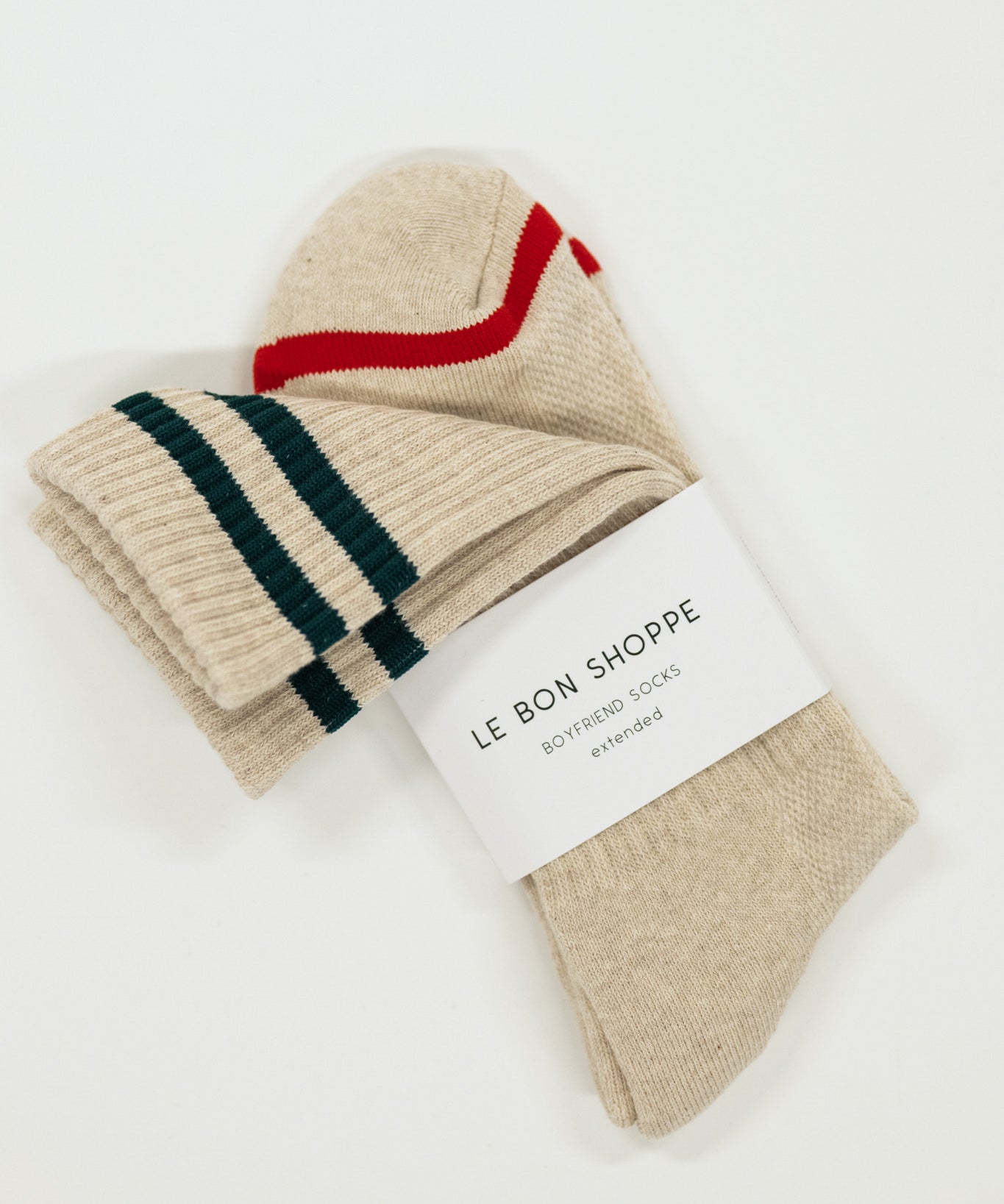 Pair of beige socks with green and red stripes on a white background, featuring 'Le Bon Shoppe' label.