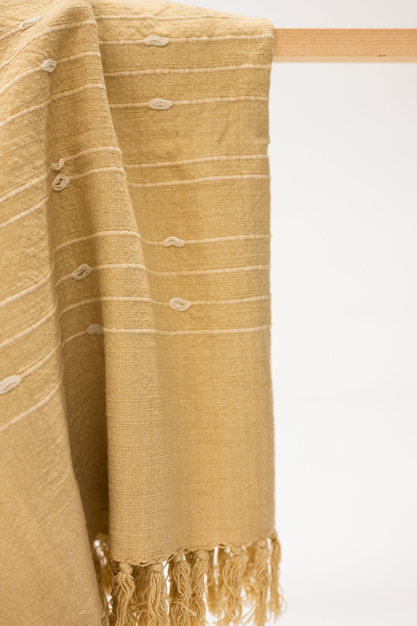 ochre yellow cotton throw blanket with tassels