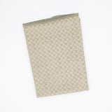 A folded microfiber dishcloth with a small-scale geometric checkered pattern in beige and muted sage green, shown on a plain white background.