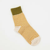 oatmeal colored socks with orange stripes and olive green crew top