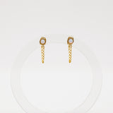 Gold chain earrings with a small round gemstone on a white background