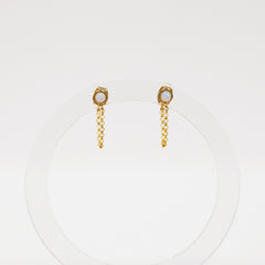 Gold chain earrings with a small round gemstone on a white background