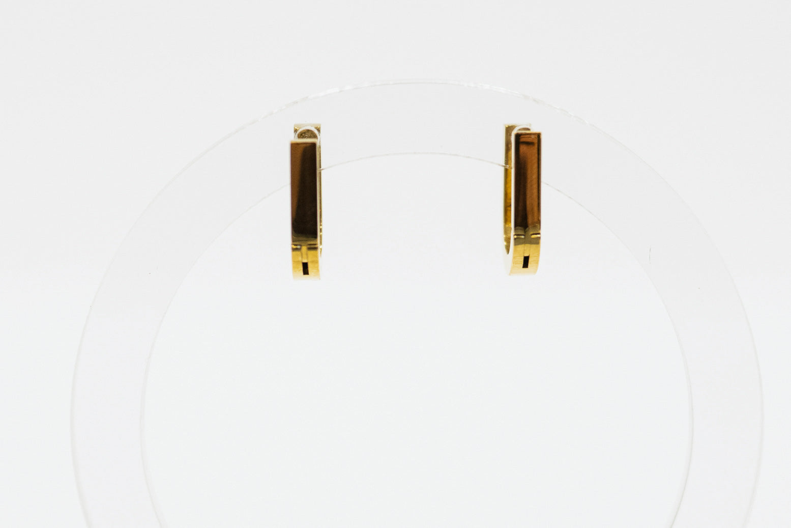 Pair of gold bar earrings on a white background