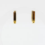Pair of gold bar earrings on a white background