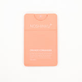 Noshinku Orange Coriander hand sanitizer in a rectangular peach-colored plastic dispenser with white text, shown on a clean white background.