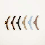 collection of original sized kaxi brand hold everything hair claw