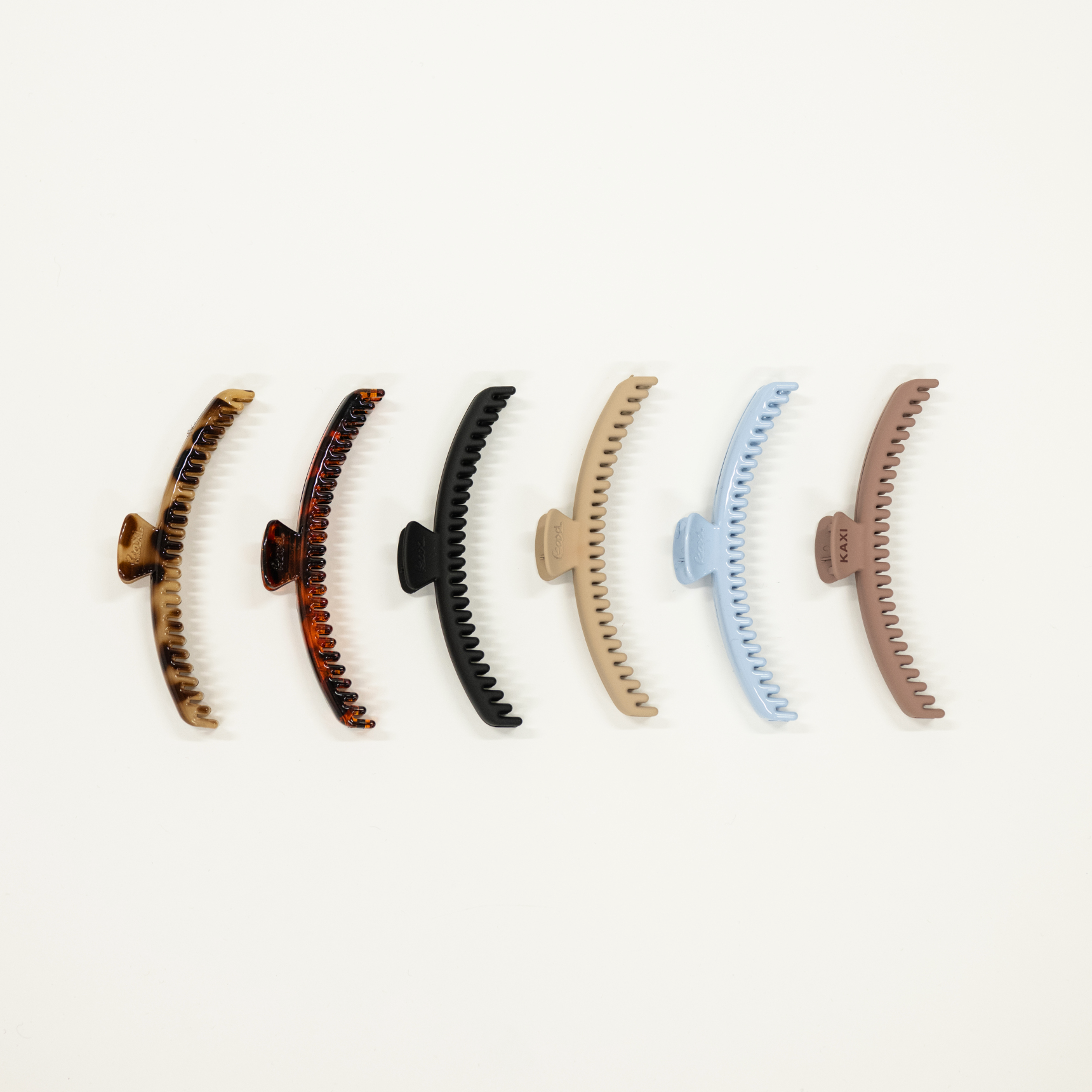 collection of original sized kaxi brand hold everything hair claw