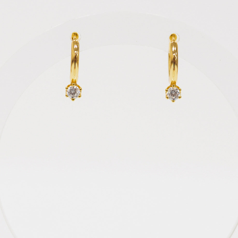 Gold hoop earrings with small diamonds on a white background