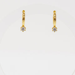 Gold hoop earrings with small diamonds on a white background