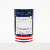 A canister of Tea With Tae Iced Tea in the Liberty Peach flavor, featuring a navy blue label with gold stars, a white center label, and red and white striped base, set against a plain white background.