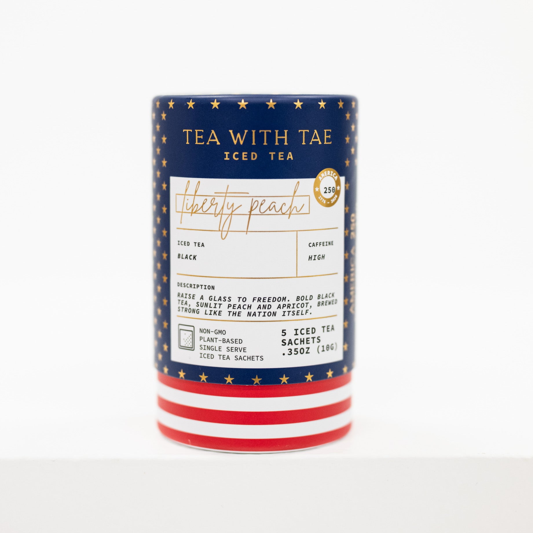 A canister of Tea With Tae Iced Tea in the Liberty Peach flavor, featuring a navy blue label with gold stars, a white center label, and red and white striped base, set against a plain white background.